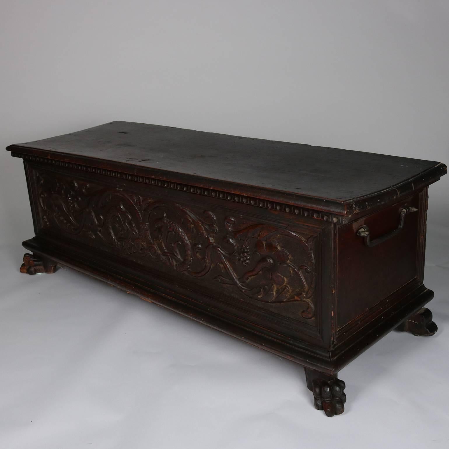 18th century Italian black walnut cassone (marriage chest) features carved foliate and dolphin front panel, egg and dart trim, paw feet, hand-forged iron handles and interior ram's head hinges.

Measures - 20" H x 55" W x 21.5" D.