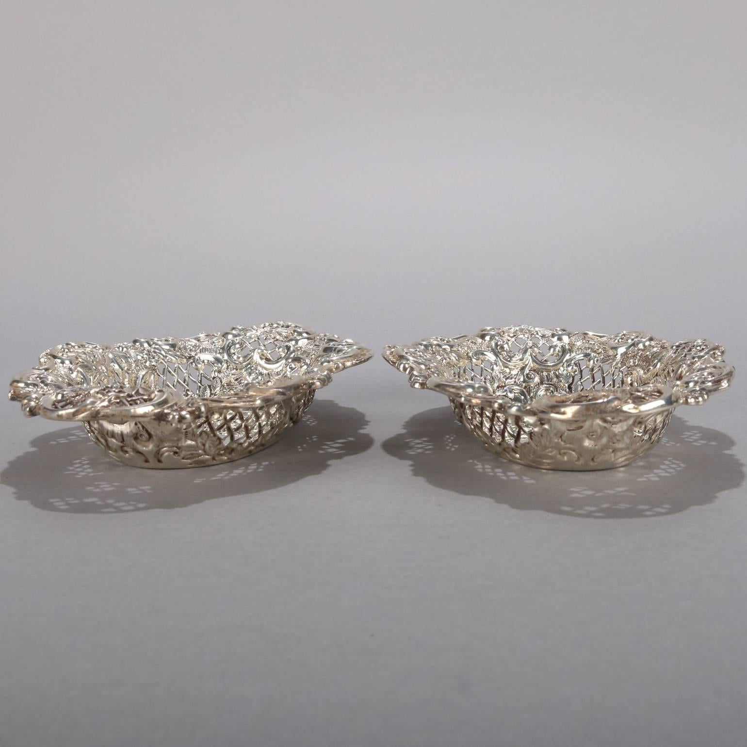 Pair of antique English repoussé sterling silver basket trays by Henry Matthews, en verso hallmarks, circa 1911.

Measure: 1.5