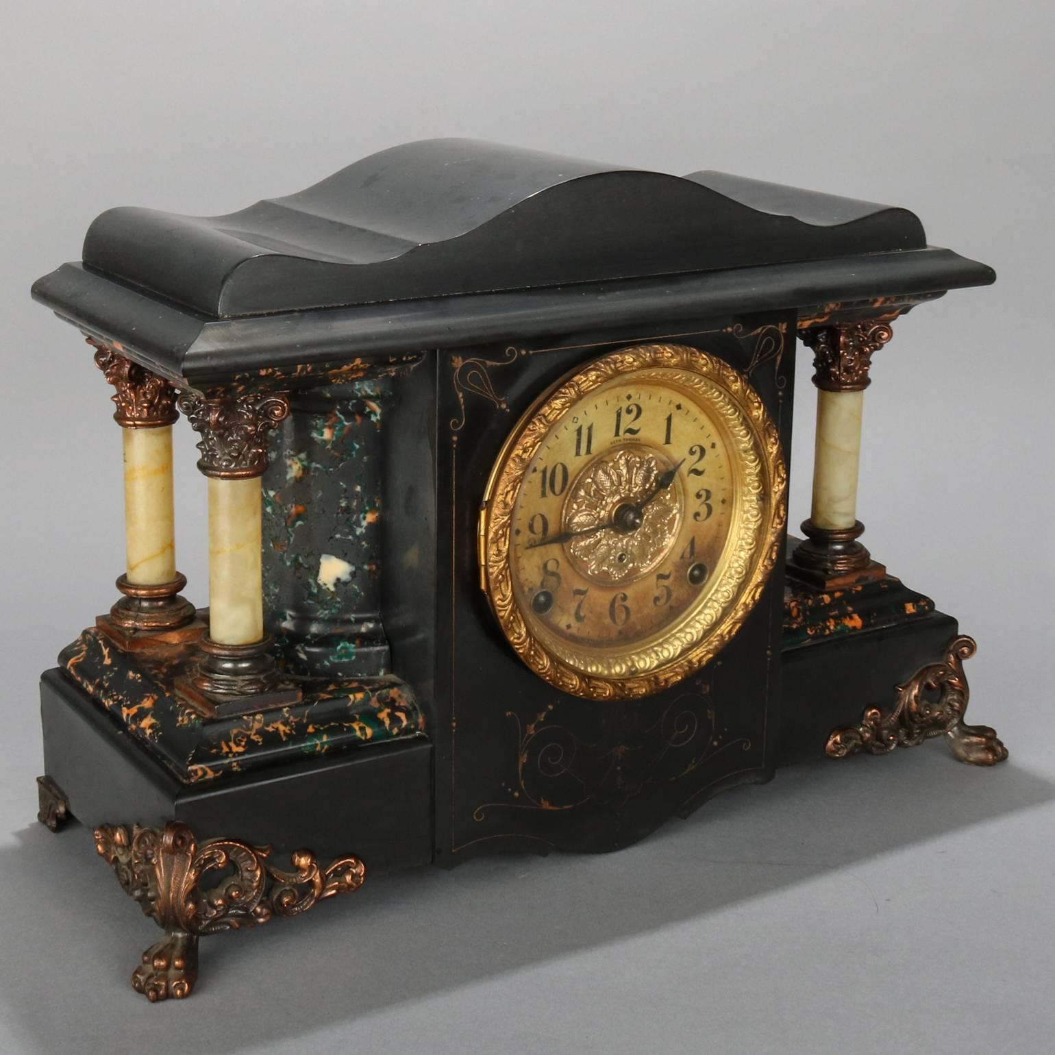 Antique Seth Thomas mantel clock features incised gilt decorated Adamantine case, flanked by faux marble demilune and full columns with cast bronze bases, capitals and feet, circa 1900

Measures: 12