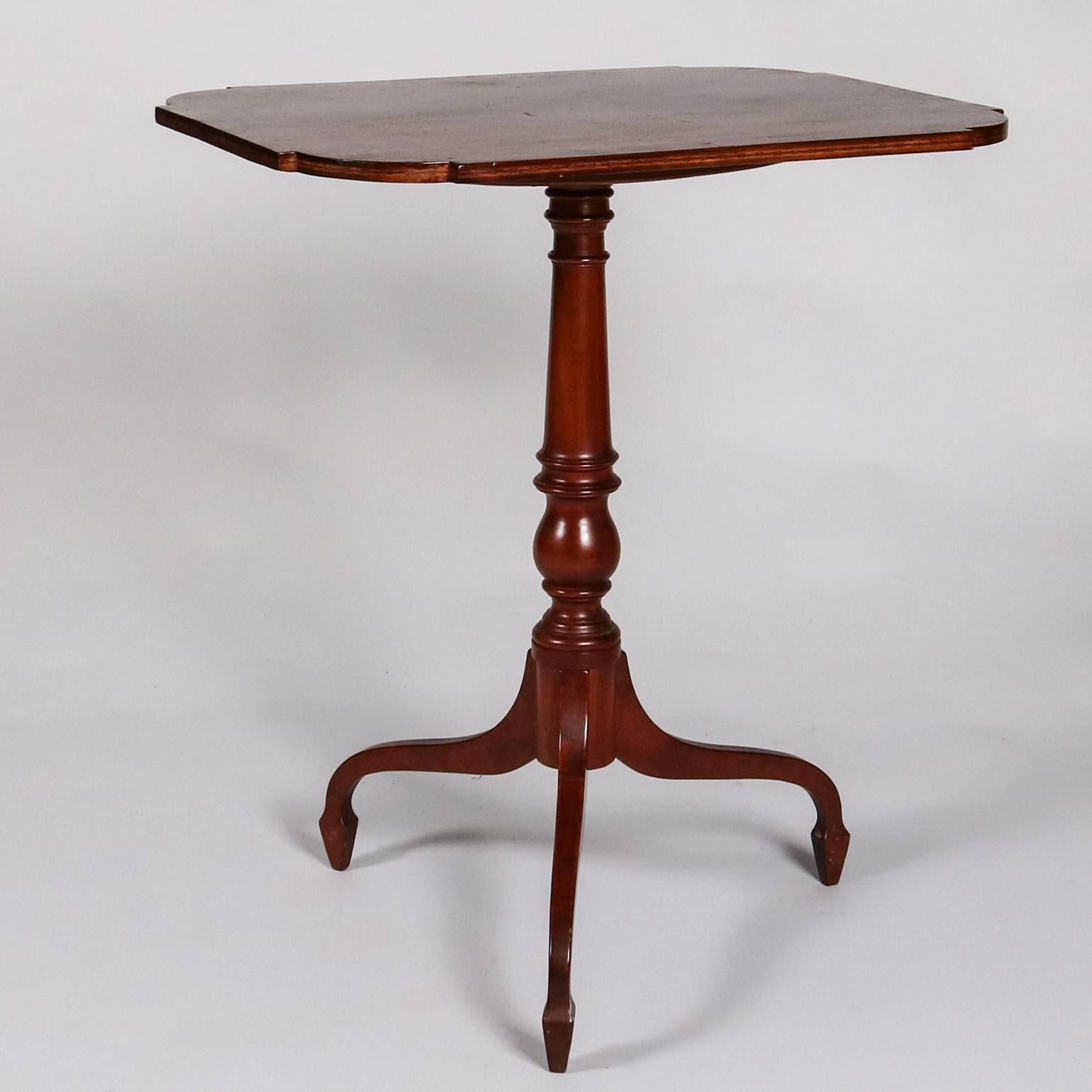Antique Federal mahogany tilt-top table features spider tripod legs and spade feet, turned column and tilt top, 19th century

Measures: 27.5" H x 24" W x 18" D.