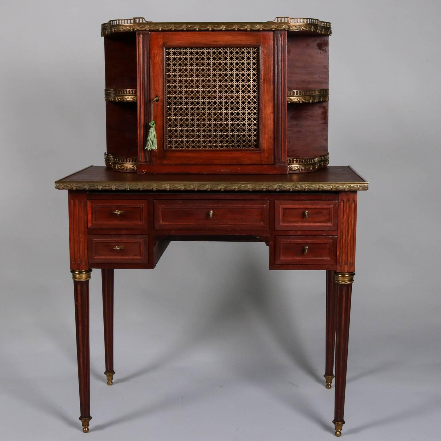 Antique French, Louis XV Bonheur de Jour (ladies secretary/desk) features mahogany case lower drawers and upper compartment with flanking display shelving, bronze gallery and accoutrements throughout, 19th century

Measures: 46.5