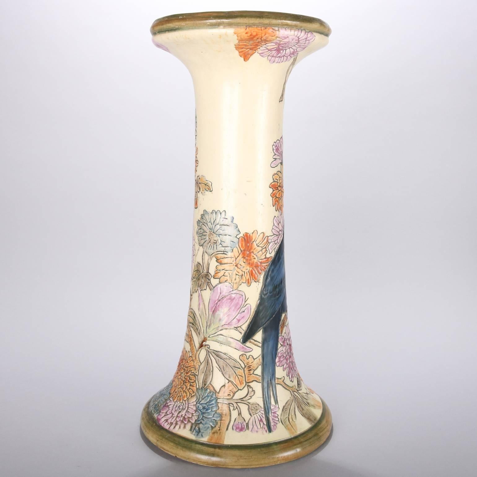 Antique Art Nouveau Weller School art pottery Flemish pedestal features hand-painted bird and floral motif (blue parrot and cockatoo among chrysanthemum blossoms) with gilt highlights, early 20th century.

Measures: 21.25" height x