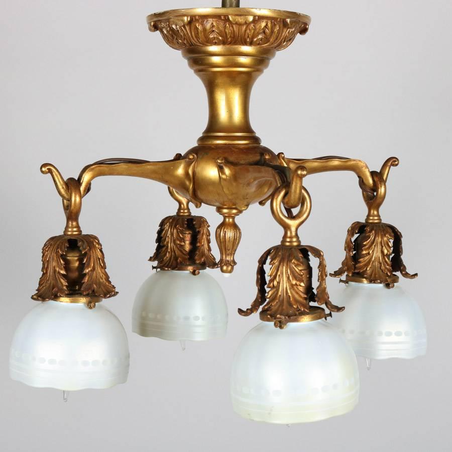 Antique Art Nouveau Tiffany School chandelier features bronze body with four branch form arms terminating in Steuben calcite shades, circa 1920

Measures: 15