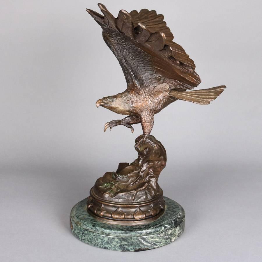 Finely detailed cast figural bronze sculpture "Strength and Honor" after Jules Moigniez depicts eagle taking flight, marble base, brass plaque on base reads "Strength and Honor, Jules Moigniez", 20th century.

Measures
