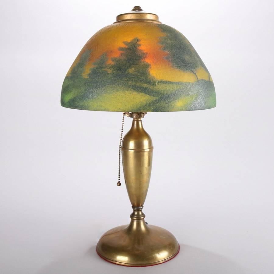 Antique Pittsburgh reverse painted single socket lamp, landscape scene, bronze base, 20th century

Measures: 20" height x 12" diameter.
