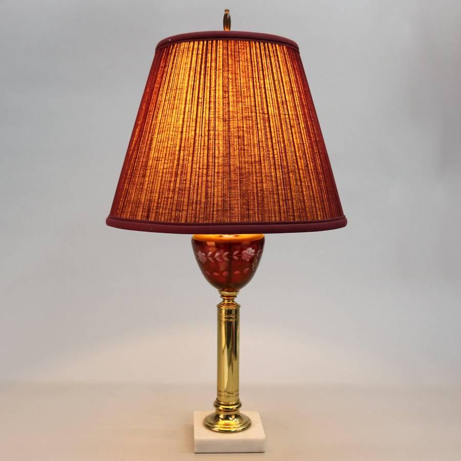 Pair of table lamps feature cranberry cut to clear floral fonts on brass columns seated on marble bases, 20th century

Measures: 26" height x 13" diameter.