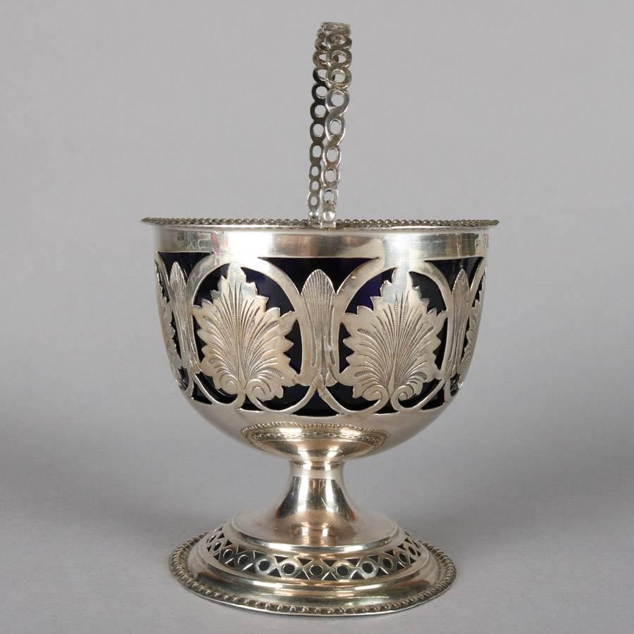 Antique English pedestal sugar basket features pierced sterling silver construction with leaf and scroll and cobalt blue glass basket, hallmarks on basket exterior, 19th century


Measures: 7.5" height x 3.75" diameter.