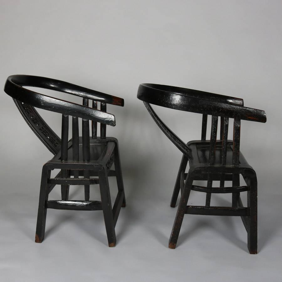 Pair of Chinese carved and ebonized side chairs feature bentwood barrel back form with pierced slat back panel, 20th century

Measure: 29" H x 20" W x 21" D, 15" seat H.
