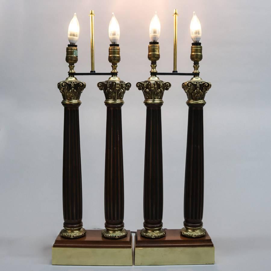Pair of classical double light table lamps feature ebonized reeded mahogany columns with cast bronze capitals and footers, lights operate independently or syncronously, 20th century

Measures: 28>5" H x 9" W x 4" D, lamps;