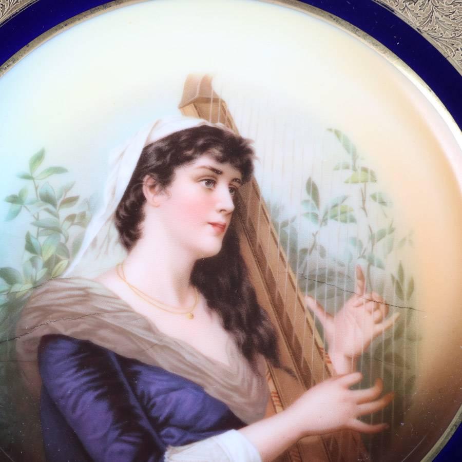 Antique German Rosenthal porcelain plate features hand-painted portrait of princess with cobalt and gilt foliate border, en verso Rosenthal mark, 19th century

Measures: 10" diameter x 1.25" height.
