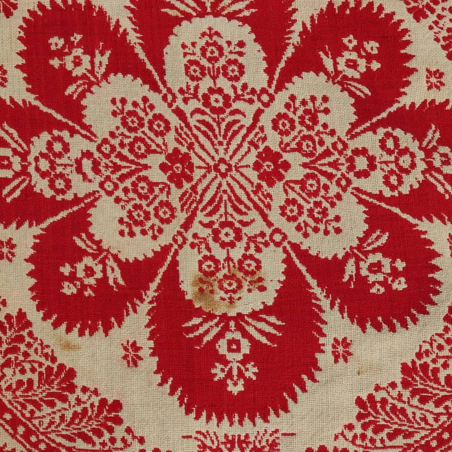 Antique loom woven jacquard coverlet features red and white repeating floral geometric patterns with foliate border, 19th century

Measures: 90" x 78".