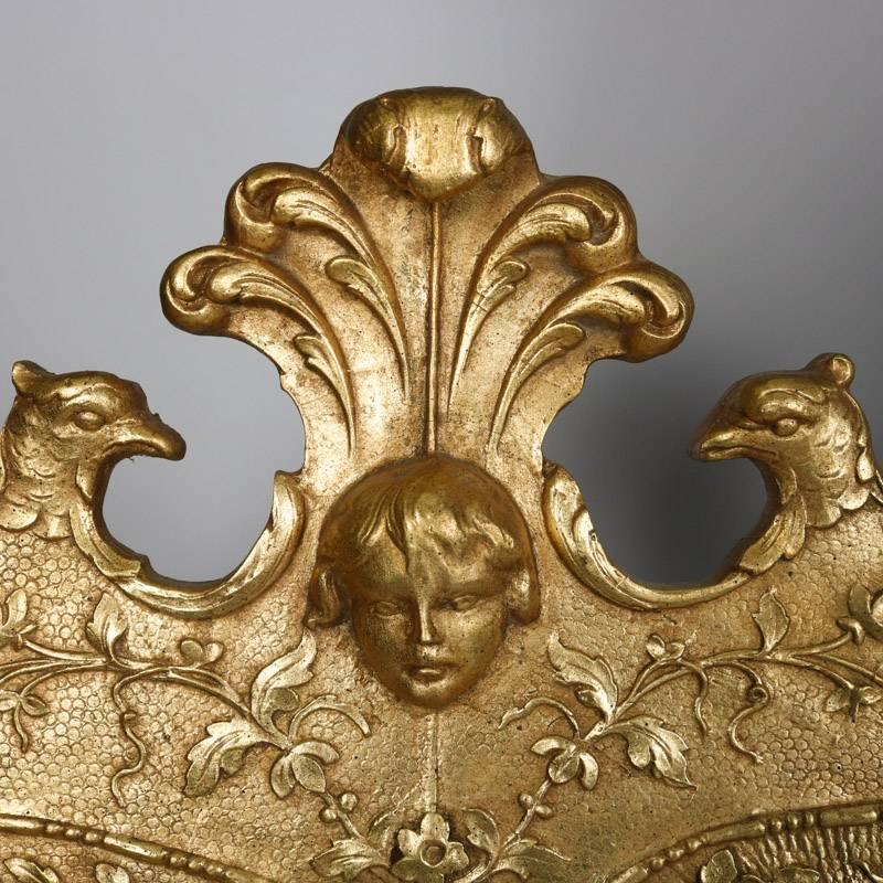 French Louis XIV style giltwood wall mirror by Henredon of the Historic Natchez collection features foliate, shell and scroll decorated frame and crest with central mask flanked by figural falcons, 20th century

***DELIVERY NOTICE – Due to COVID-19