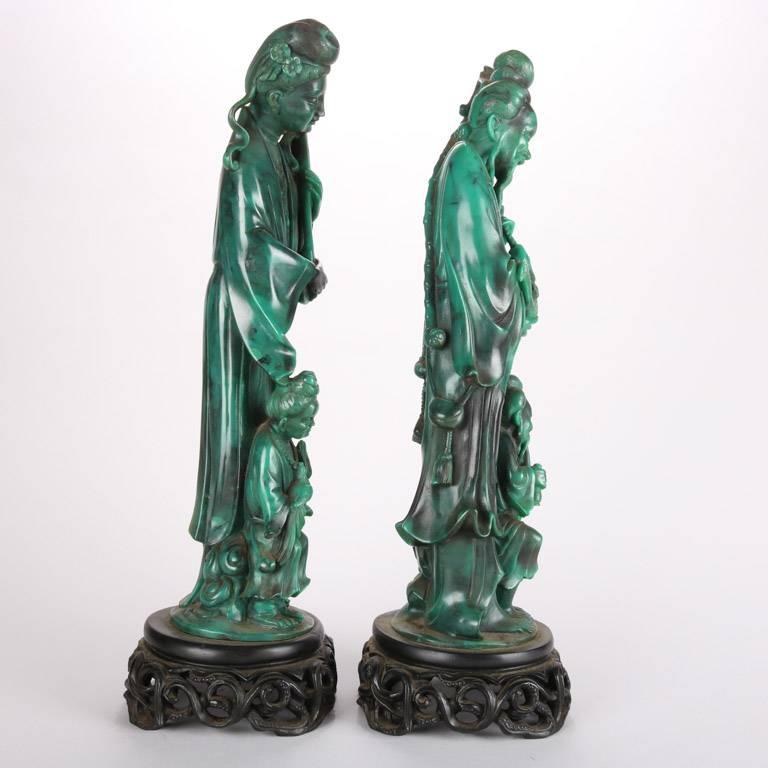 Chinese carved jade figural sculptures depicting woman and fisherman with elements of music and peace (doves / birds), signed chop marks, seated on carved stands, 19th century

Measures: 17" height x 5" diameter.