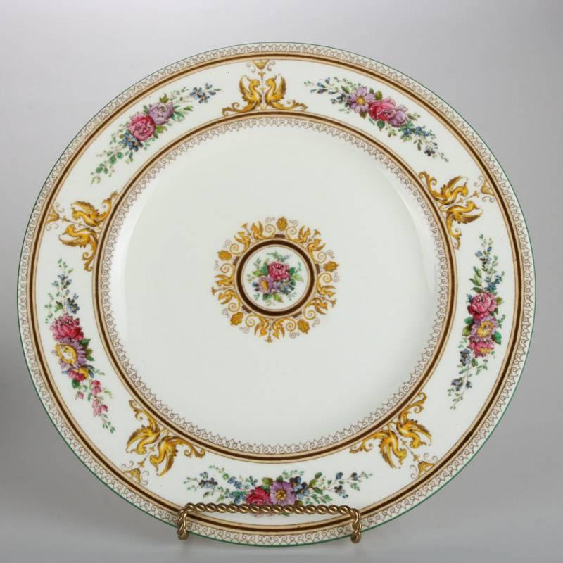 Antique set of 11 classical Wedgwood fine bone china plates in Columbia pattern features hand painted floral border and central medallion with gilt trim and highlights, 19th century

Measures: 10.75