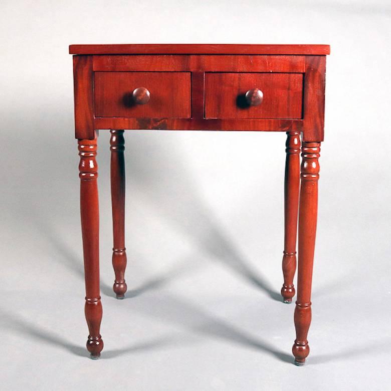 Antique Sheraton end table features cherry construction with two drawers and seated on turned legs, 19th century

Measures: 29.25