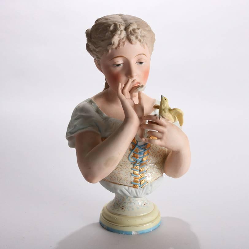 Antique English Chelsea school bisque porcelain 3/4 bust features young woman feeding her yellow canary (bird), hand painted figure with gilt highlights, seated on foliate decorated plinth, signed on base with script "K", 19th