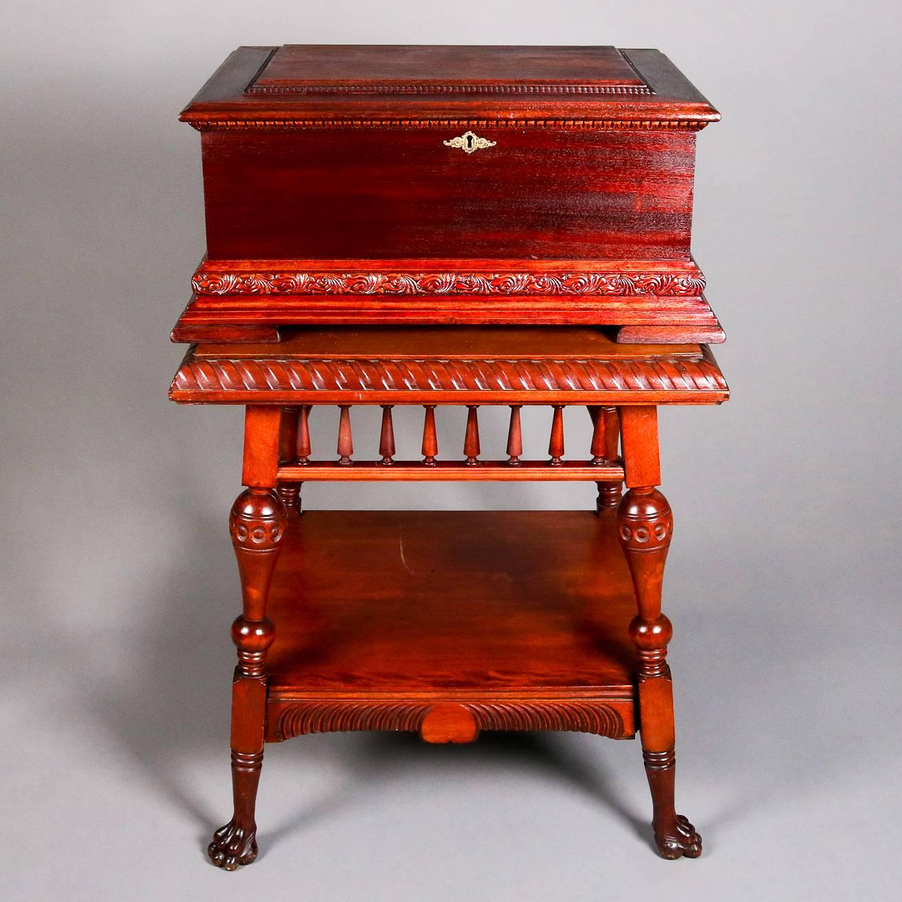 Antique Stella double comb music box features mahogany case and sits on carved claw foot stand, music box in working condition, includes Yankee Doodle disc, 19th century

Measures: 42