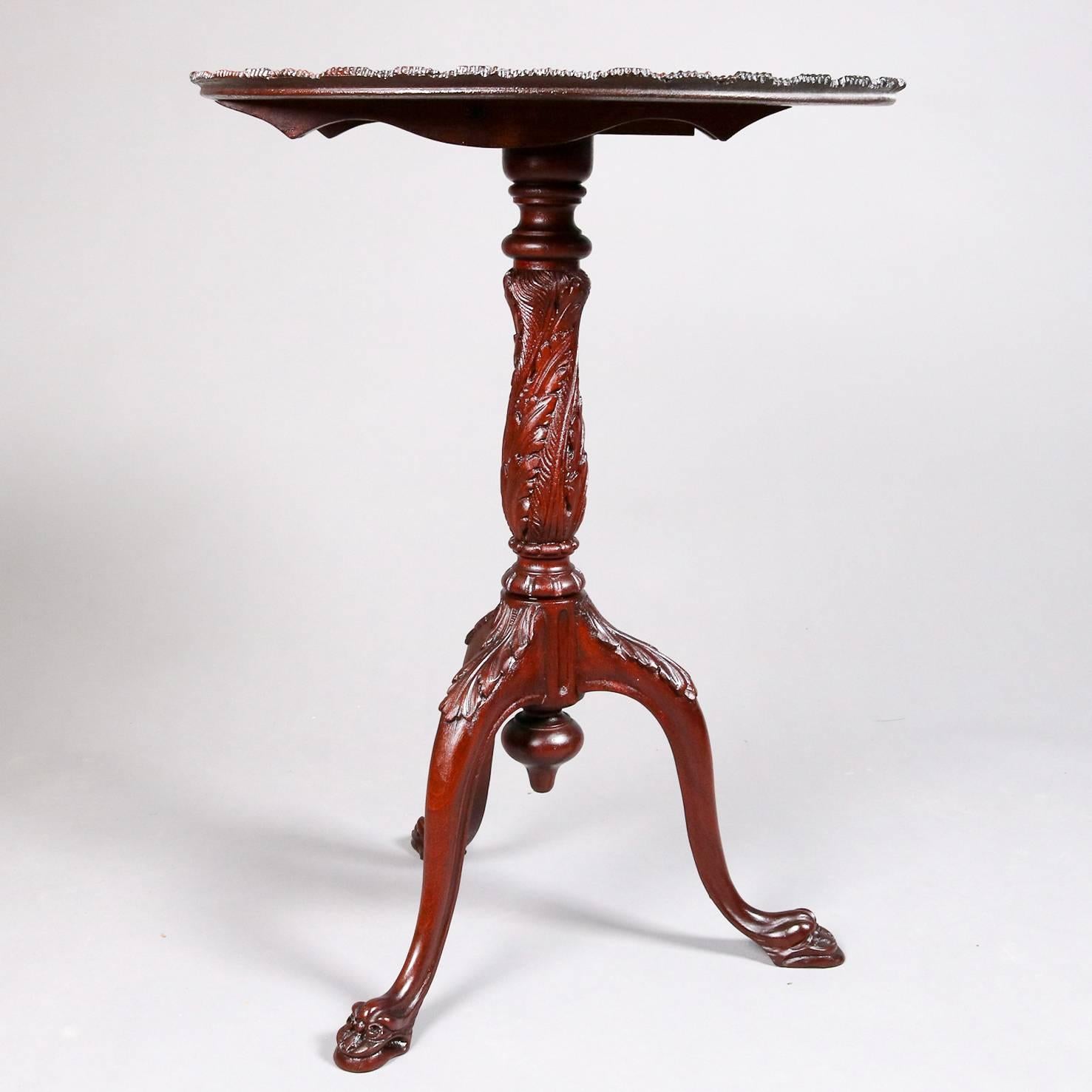 Antique mahogany tilt top table features carved pie crust top with central rosette, acanthus decorated plinth and tripod cabriole legs terminating in figural feet with central drop finial, 19th century

Measures - tilt: 42" H, 30" H x