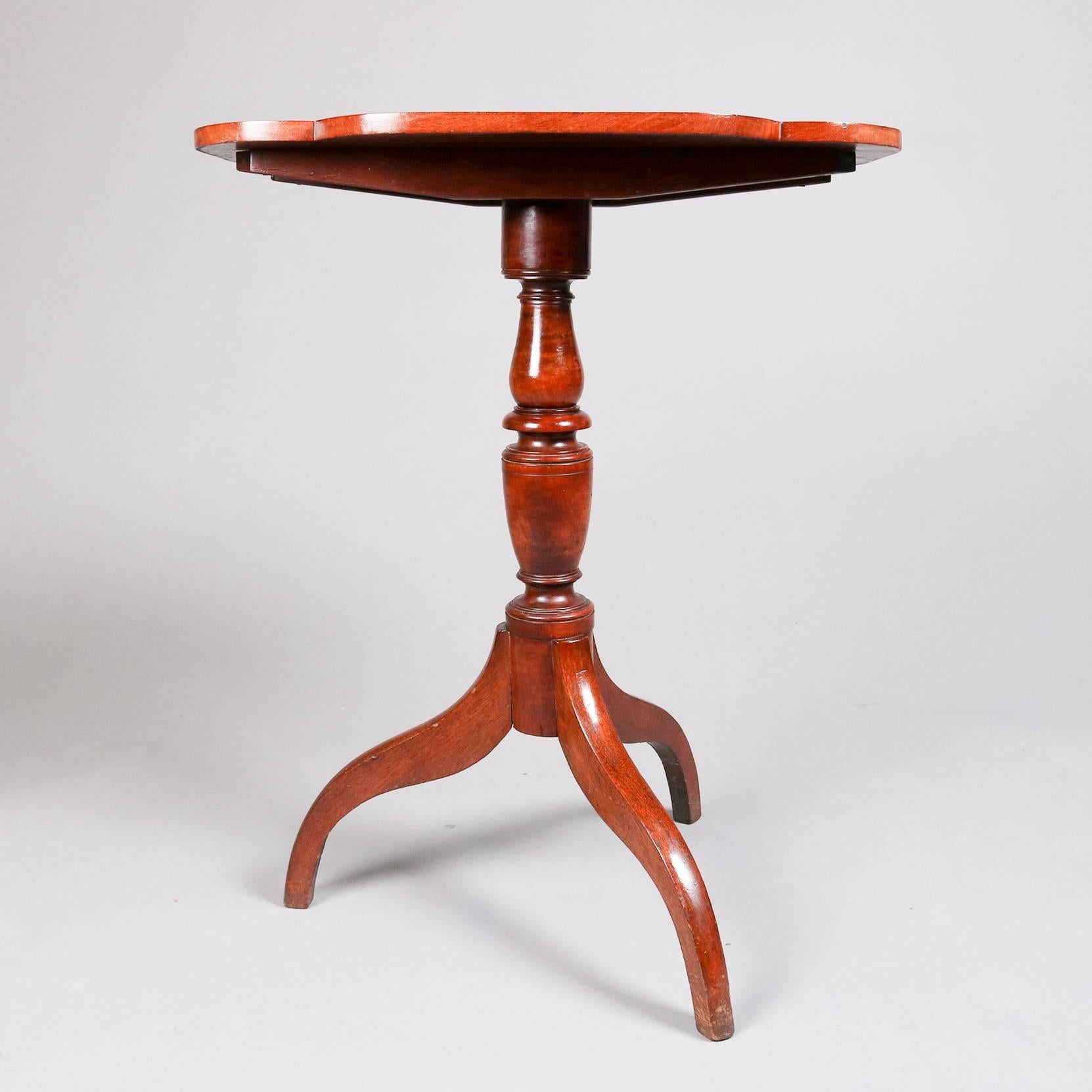 Antique Federal candle stand features mahogany construction with shaped tilt top, turned plinth and spider legs, 19th century

Measures - tilt: 42