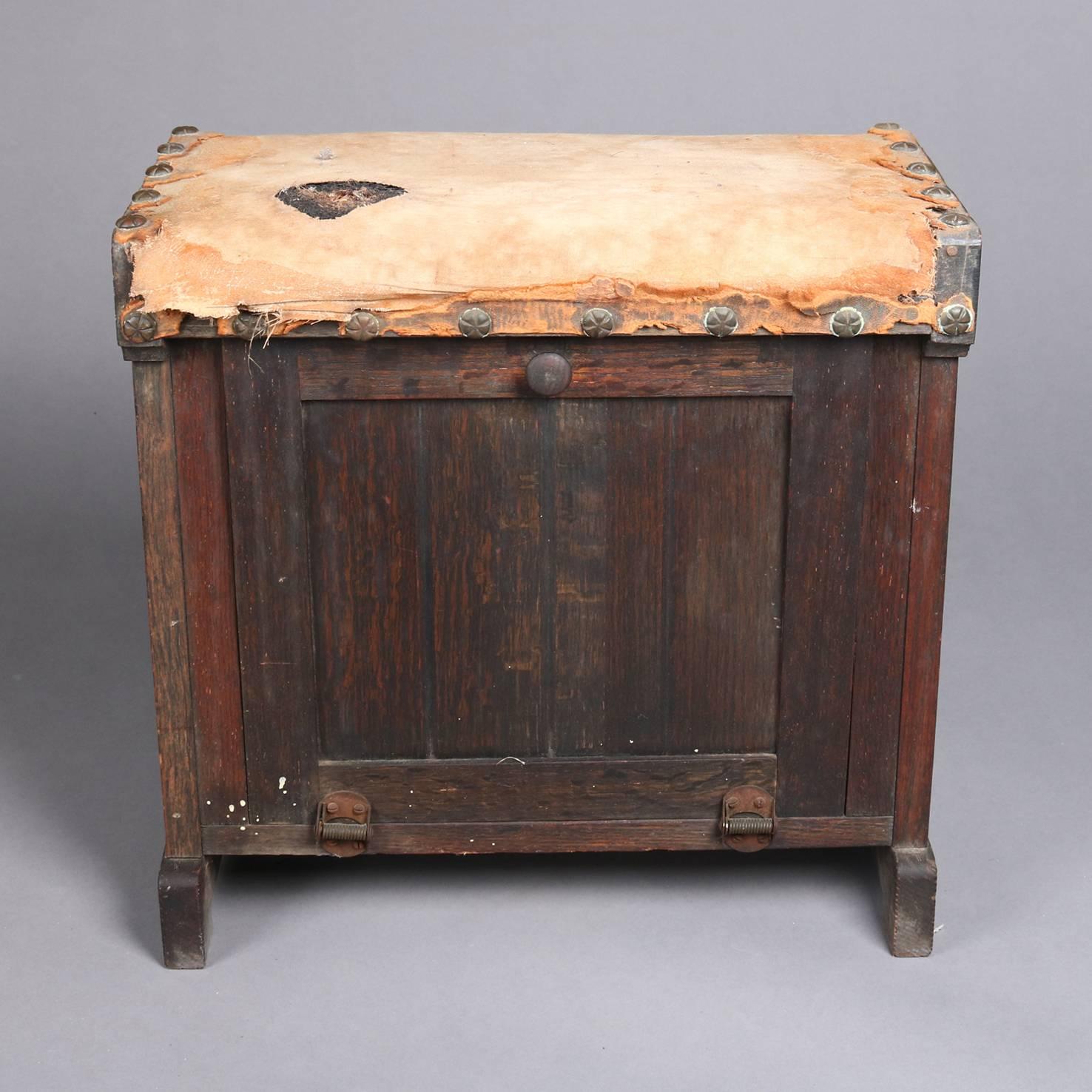 Early Primitive Arts & Crafts style antique shoe shine box and stool features grain painted wood construction with drop front door opening to interior storage compartment and upholstered seat, early 20th century

Measures - 16" H x