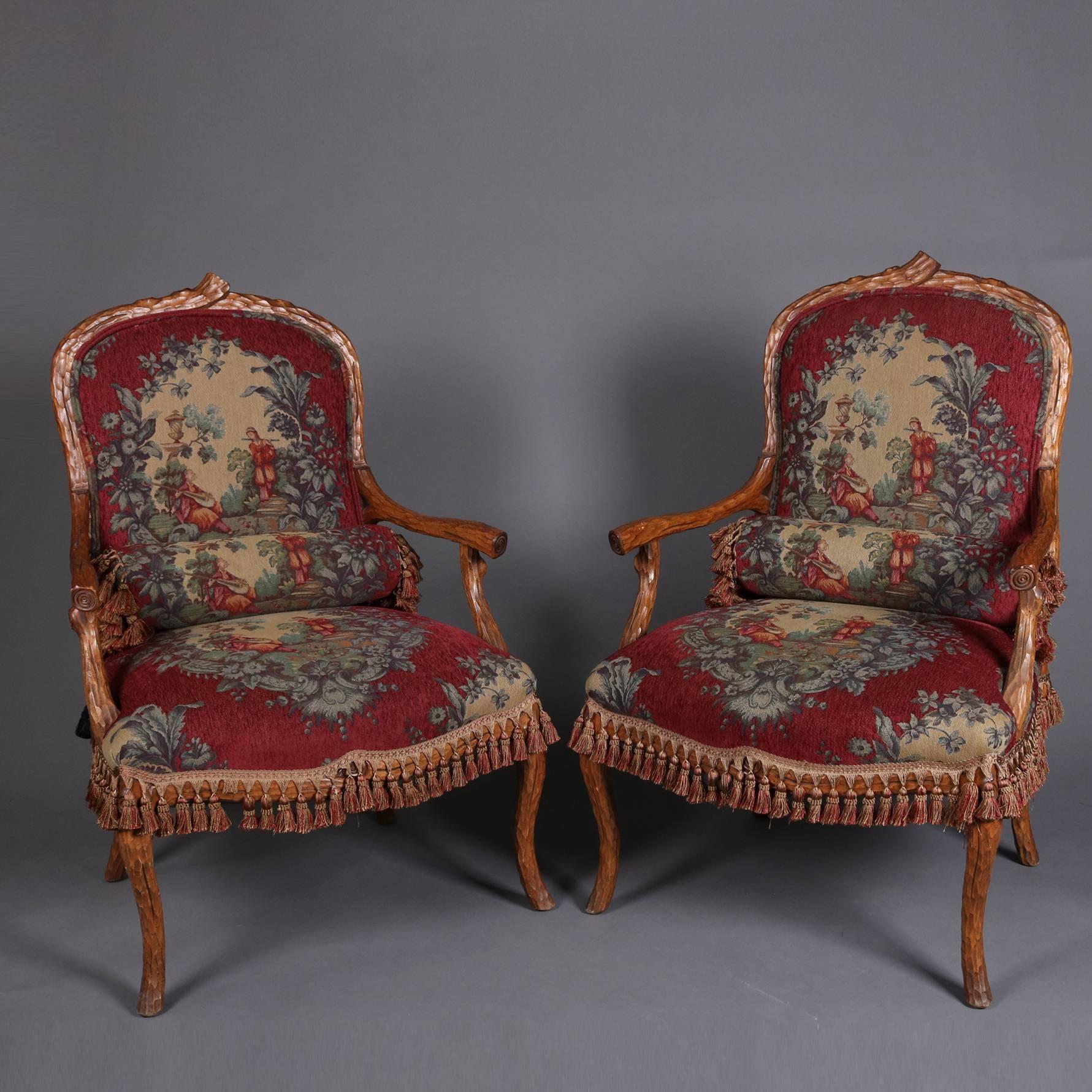 Pair of antique armchairs feature carved walnut stick form frame with tapestry upholstered seats and backs, tassel trimming, 19th century

Measures: 41