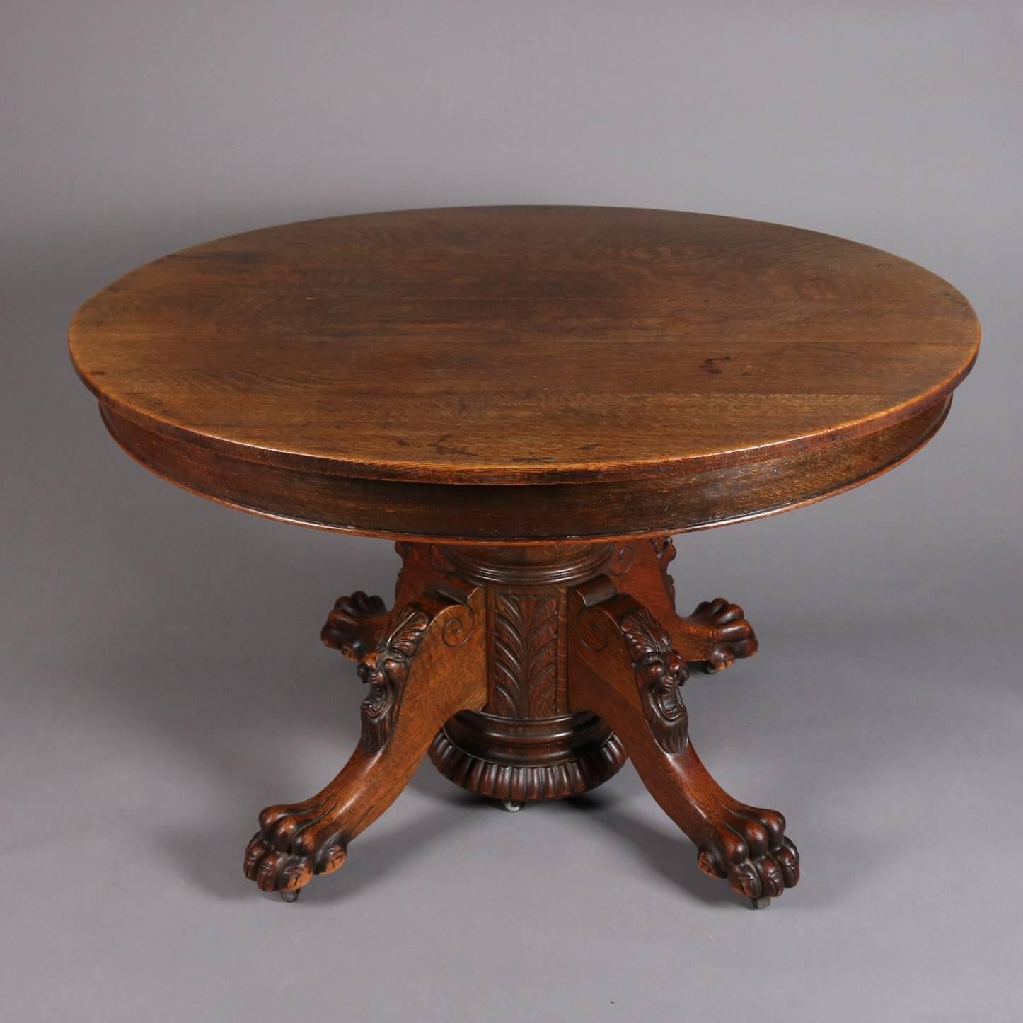 Antique figural dining table features carved lion heads and paw feet, split pedestal base seated on four legs, and 12" three leaves, 19th century

Measures 30", h x 48