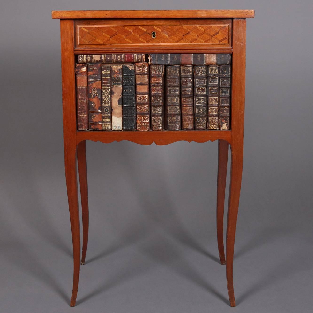 Antique French Louis XVI style satinwood parquetry inlaid table features faux book case front and parquetry inlaid top opening to interior compartment, seated on cabriole legs, 20th century.

Measures 31