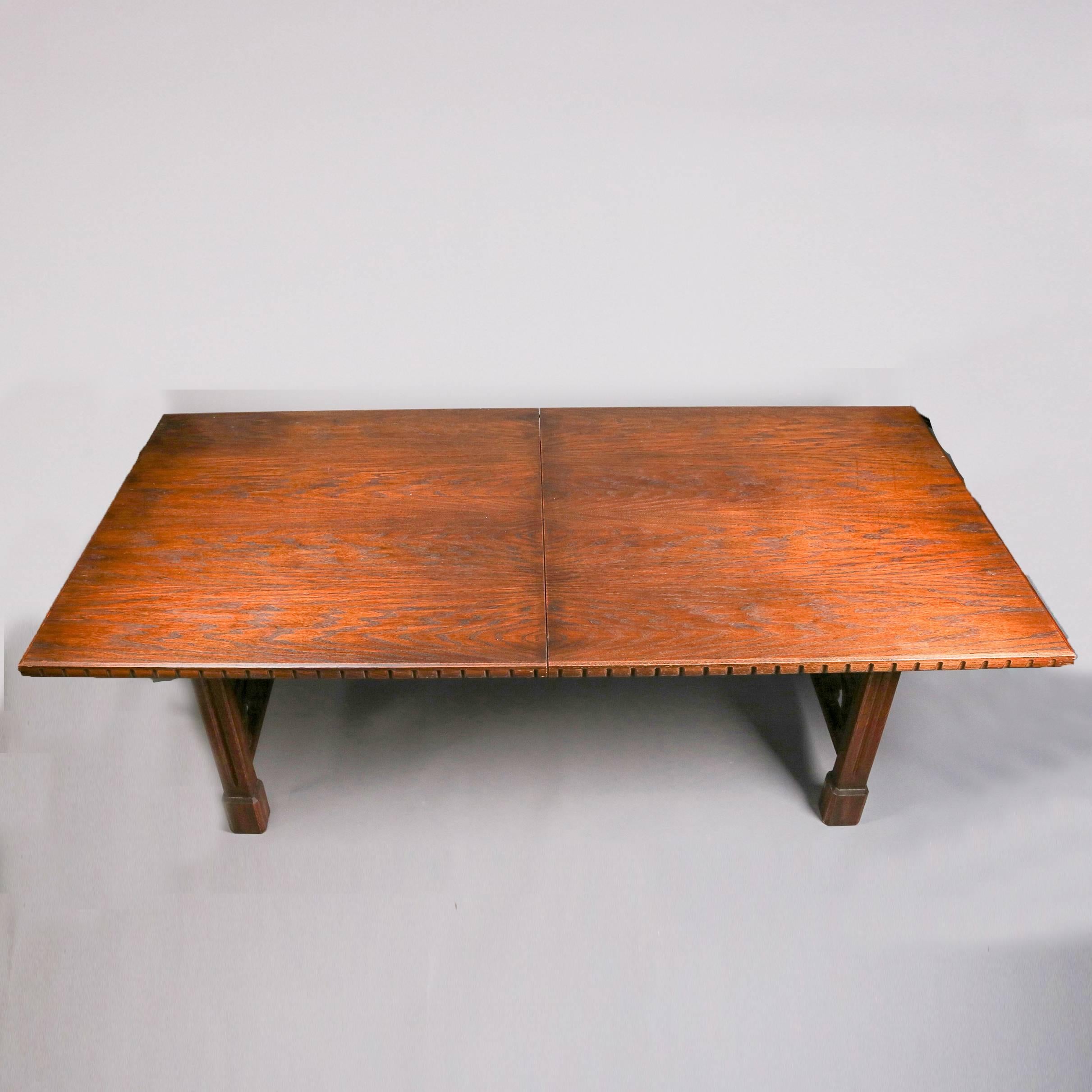 Antique English walnut Gothic trestle table features cathedral arch form carved and pierced sides and dental form carved edges, with two leaves, 19th century

Measures:  29.5" H x 90" W x 44" D, 2 leaves 18" W each, 126" W