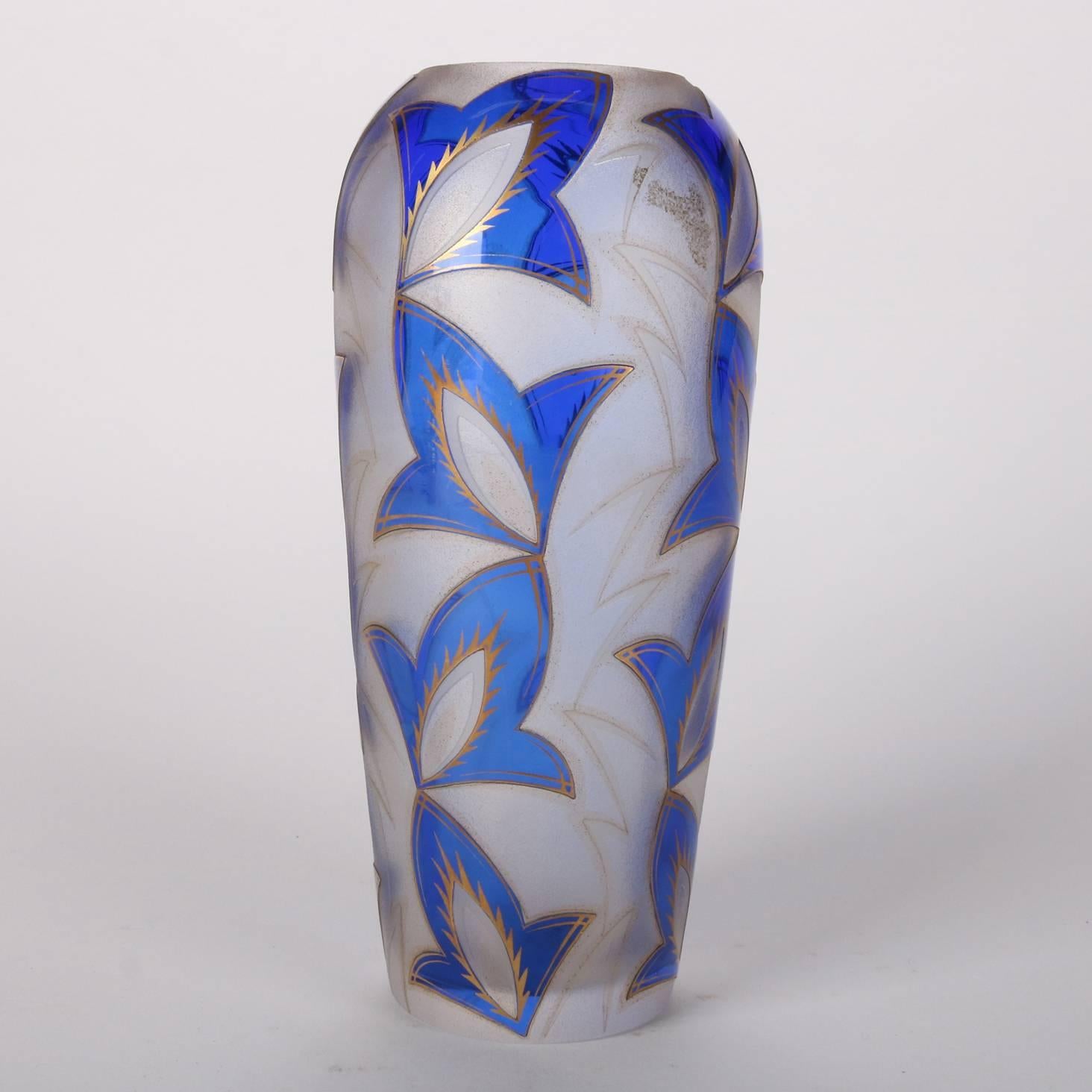 Antique Art Deco Daum Nancy School cut back glass vase feature cobalt blue stylized leaf pattern with gilt highlights, 20th century.

Measures: 8.75