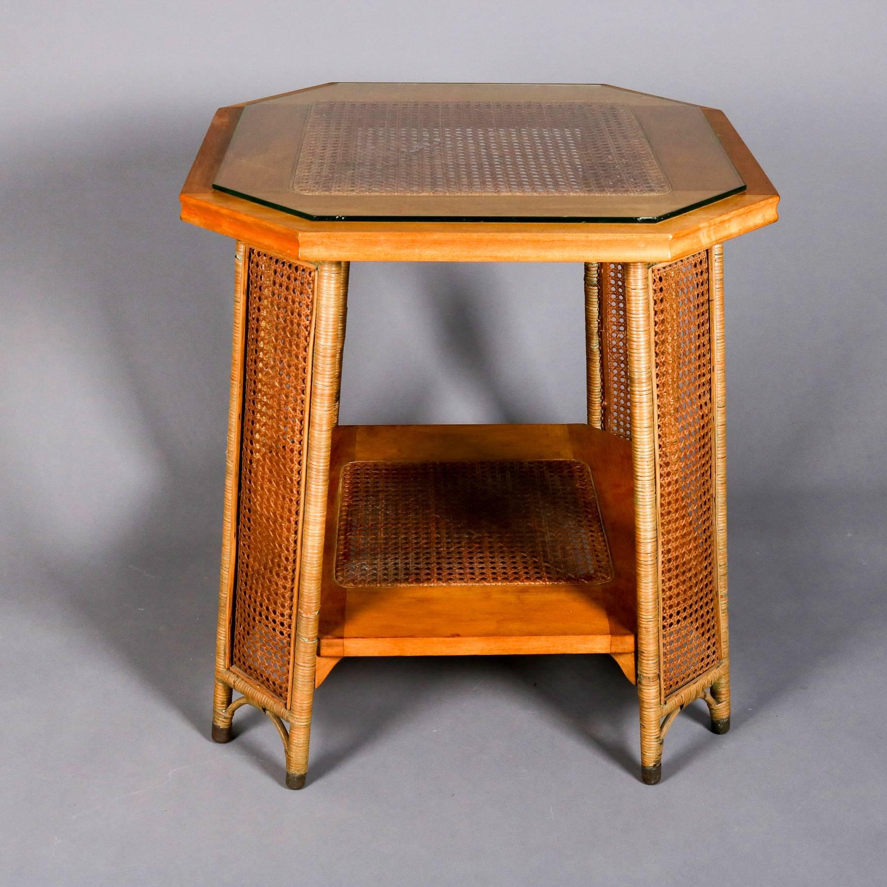 Heywood Wakefield lamp or plant stand features yew wood construction, having wicker wrapped legs with caned panels, top and lower display with caning, glass top, partial tag attached, 20th century

***DELIVERY NOTICE – Due to COVID-19 we are