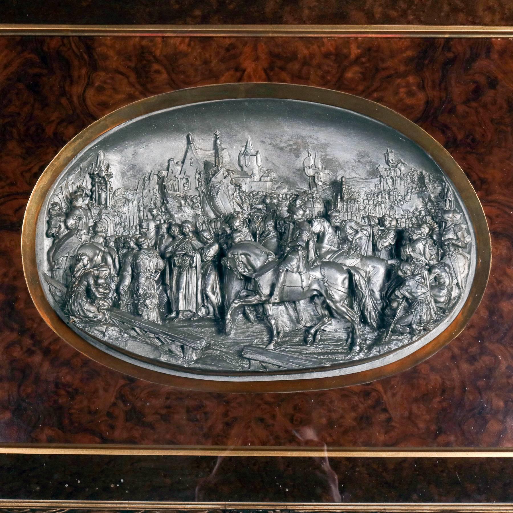 Antique Gothic cast high relief scene depicts peasant villagers and warriors on horseback with cityscape background, set in gilt and burl shadow box frame, 19th century

Measures: 22.5