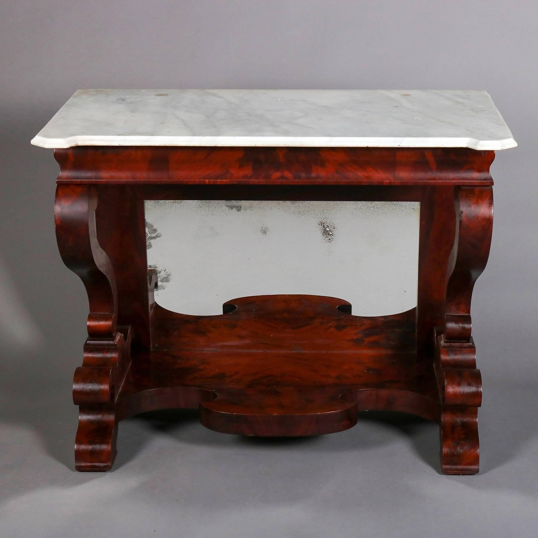 Antique Joseph Meeks School Classical American Empire flame mahogany pier table features open sides with s-scroll supports and scroll form base, mirrored apron, and marble top, reminiscent of work by Quervelle and Joseph Meeks, 19th