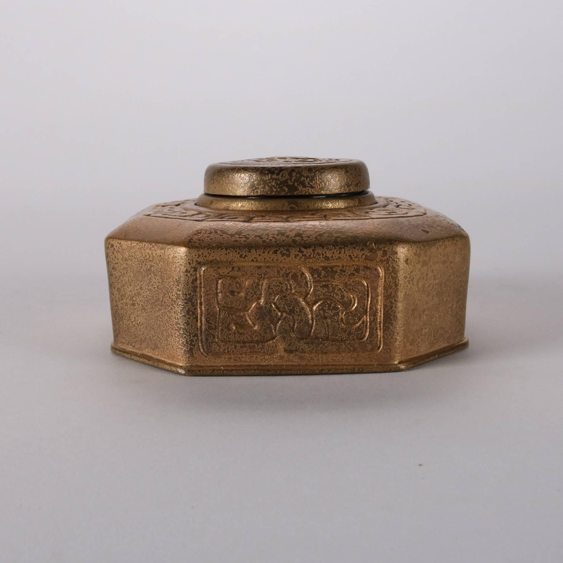 Antique Tiffany Studios New York bronze doré zodiac inkwell features octagonal form with stylized zodiac and Greek key pattern with Cancer crab on lid which opens to reveal glass ink insert, base signed Tiffany Studios 342, early 20th