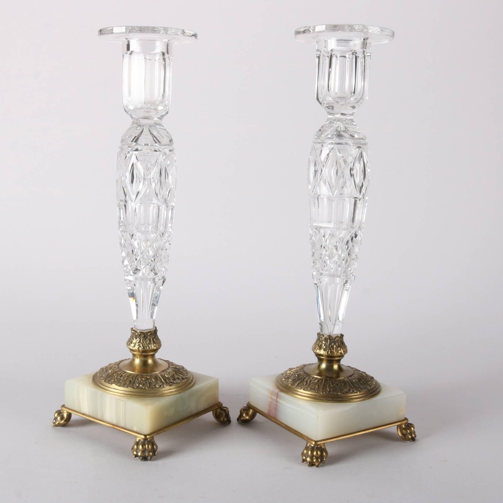 Pair of antique candle sticks by Pairpoint feature cut crystal shafts and receivers mounted on onyx bases with embossed brass attachments including paw feet, on base maker mark and C6184, 20th century

Measure - 12" H x 4.5" W x