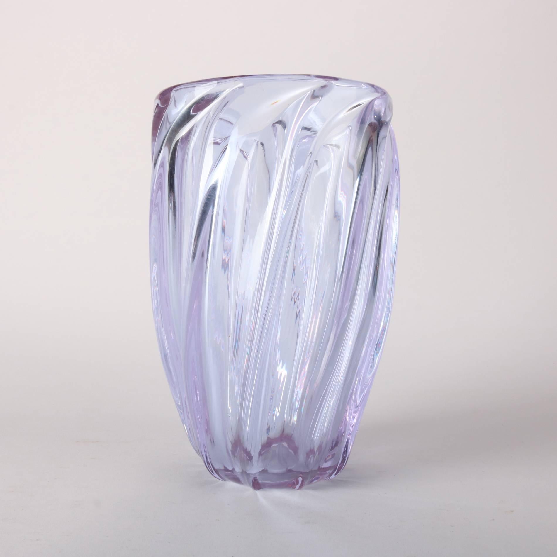 Antique French Baccarat School lead crystal vase features twist form in sky blue glass, 20th century

The glass is sky blue in color, however, in photographing, appears violet.

Measures: 10" x 6.5" diameter.