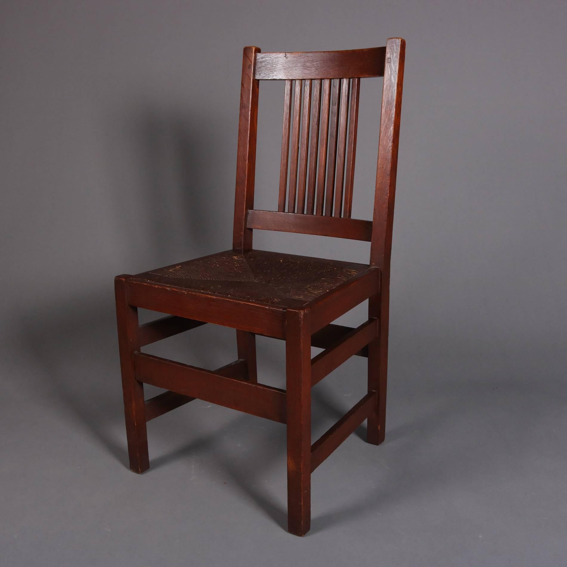 Four antique Arts & Crafts Mission Oak chairs by L. & J. G. Stickley feature spindle backs and rush seats, original labels, 20th century
 

Measure - 36