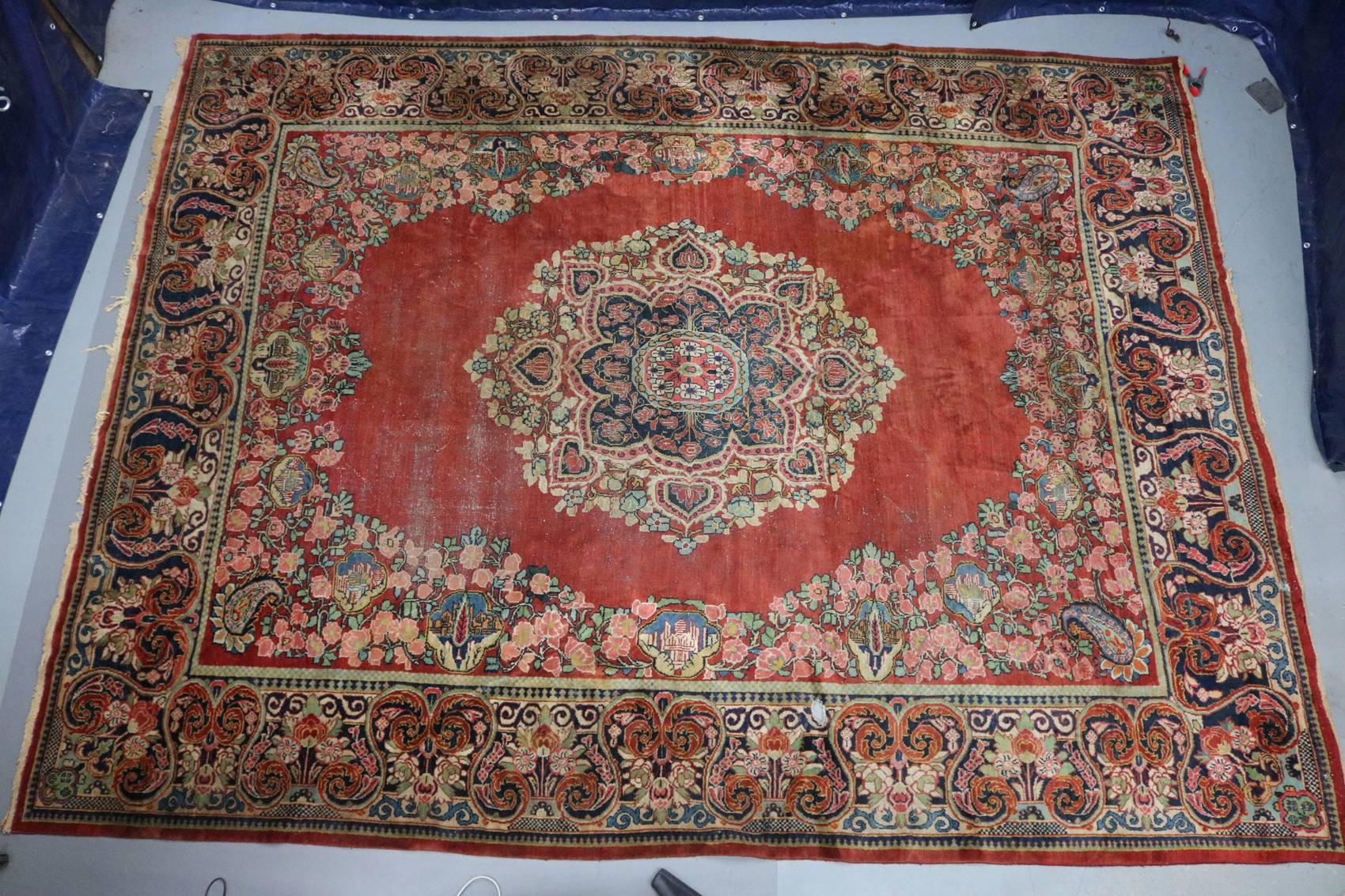 Antique hand knotted Persian oriental Mahal carpet features central floral medallion on red ground and with floral and scroll border, early 20th century

Measures - 13.75' x 10.5'