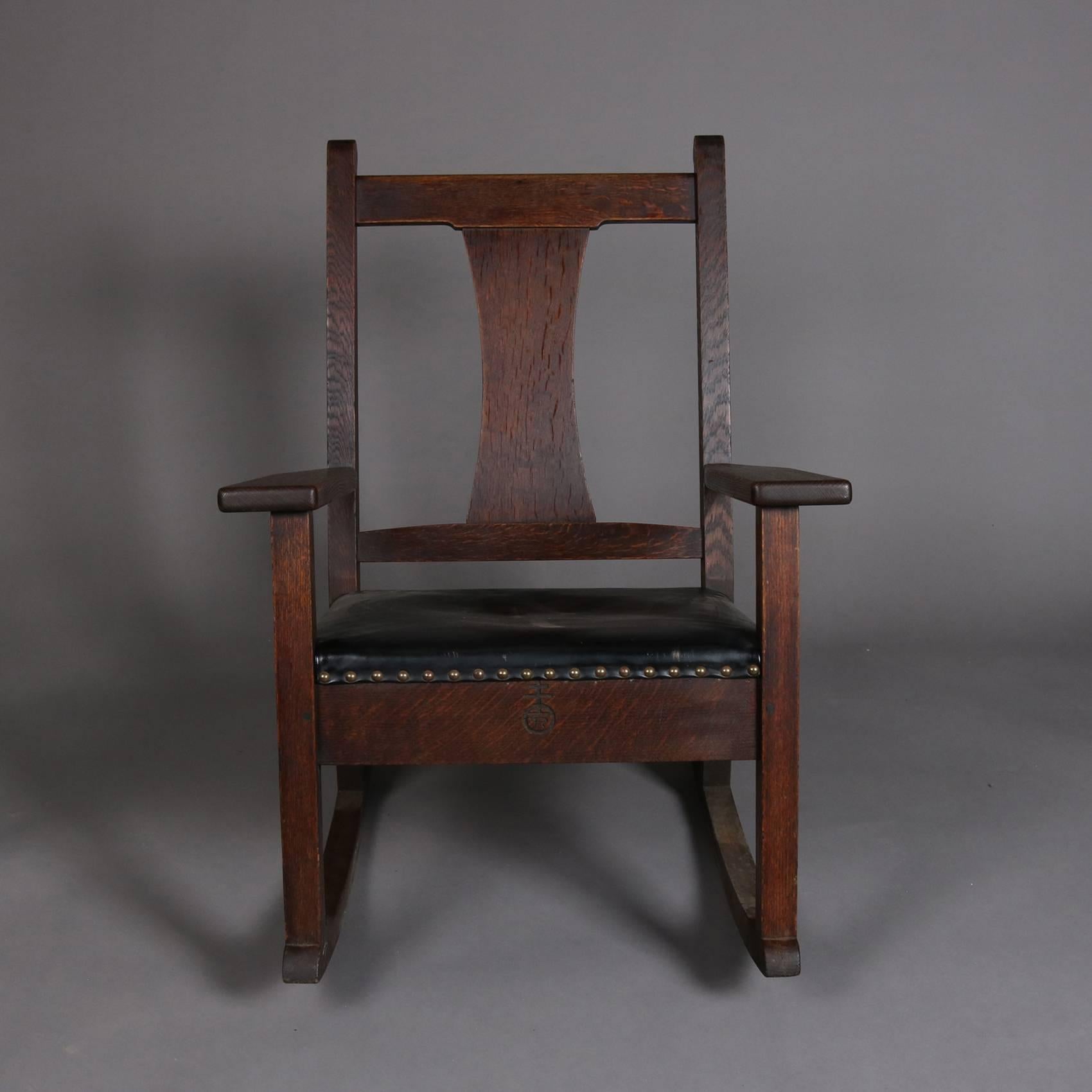 Antique Arts & Crafts mission oak rocker by Roycroft features slat back and upholstered seat, signed with Roycroft brand on back as photographed, early 20th century

Measures: 35" H x 27" W x 32" D, 15" seat height.
