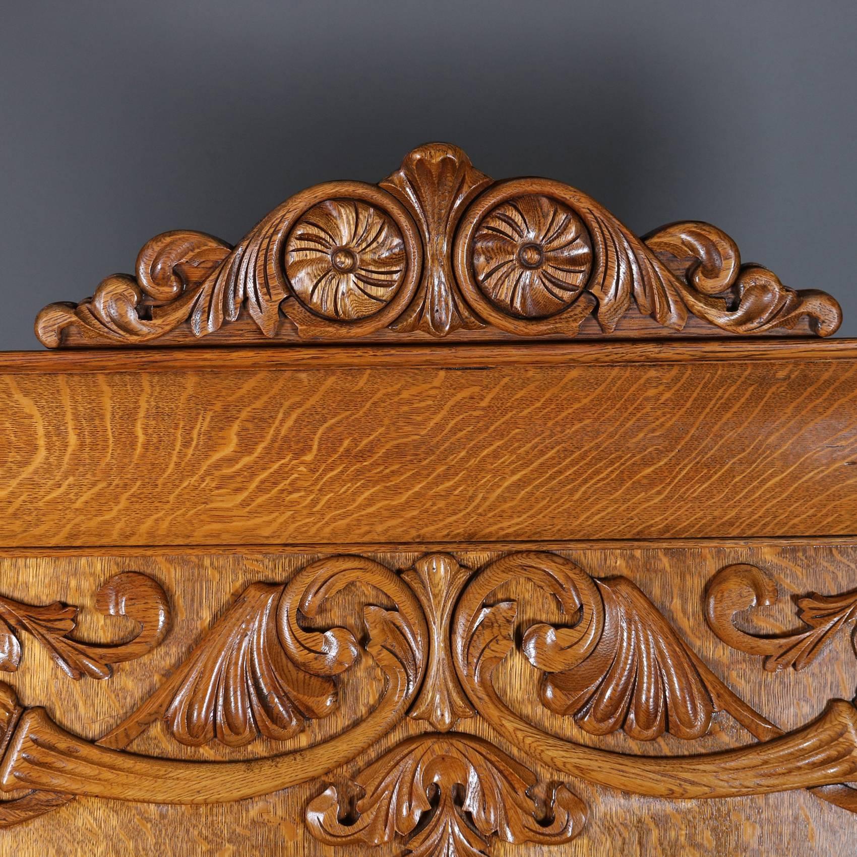 Antique full bed features quarter sawn oak construction with  carved foliate crest and flanked by carved acanthus supports, 19th century

*Matching dresser listed separately*

Measures - 79"h x 57"w; interior 75" x 54"