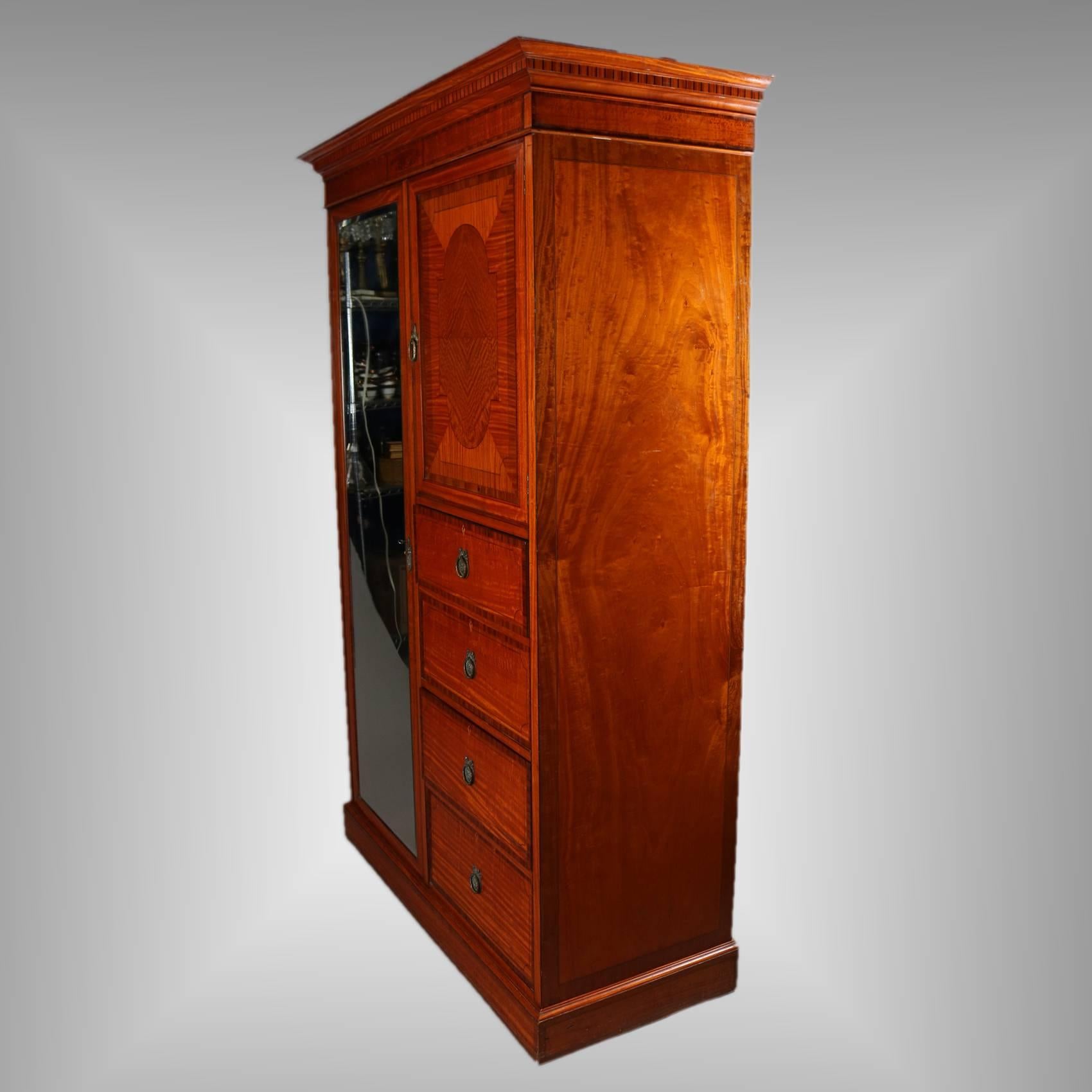 Antique English Edwardian chifferobe features closet with full length dressing mirror, 4 drawers and bonnet cabinet with inlay central reserve, ebonized banding throughout, garland and foliate form pulls, 19th century

Measures - 81"h x