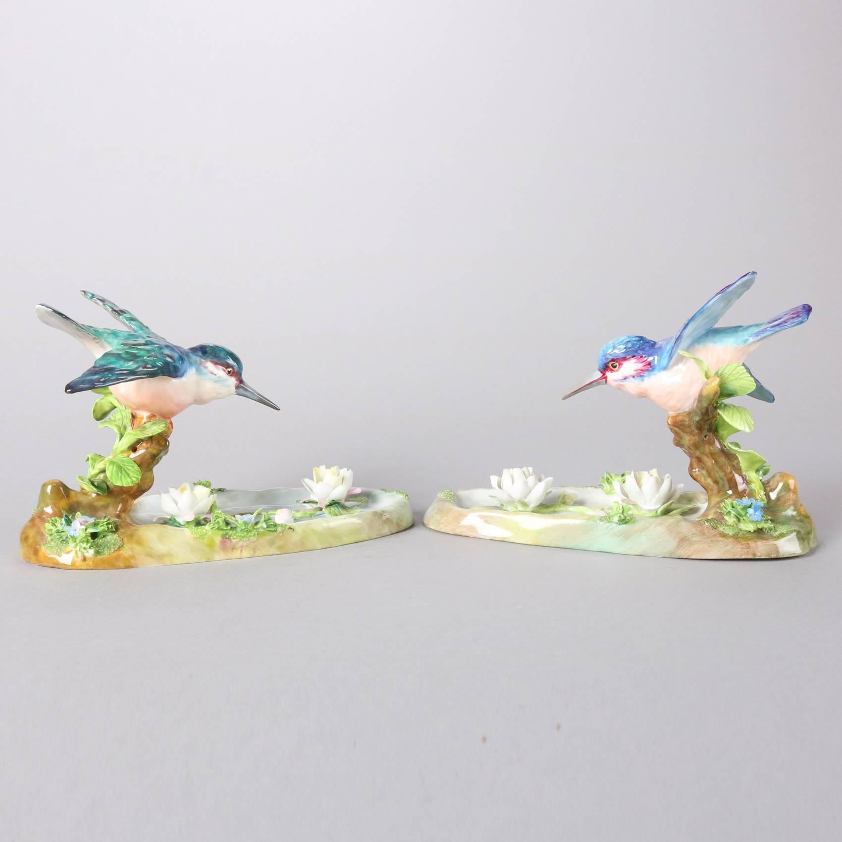 Pair of antique English Staffordshire hand painted porcelain King Fishers in flight by J. T. Jones, signed on bases, 20th century

Measure: 5" H x 7.75" W x 8.5" D.