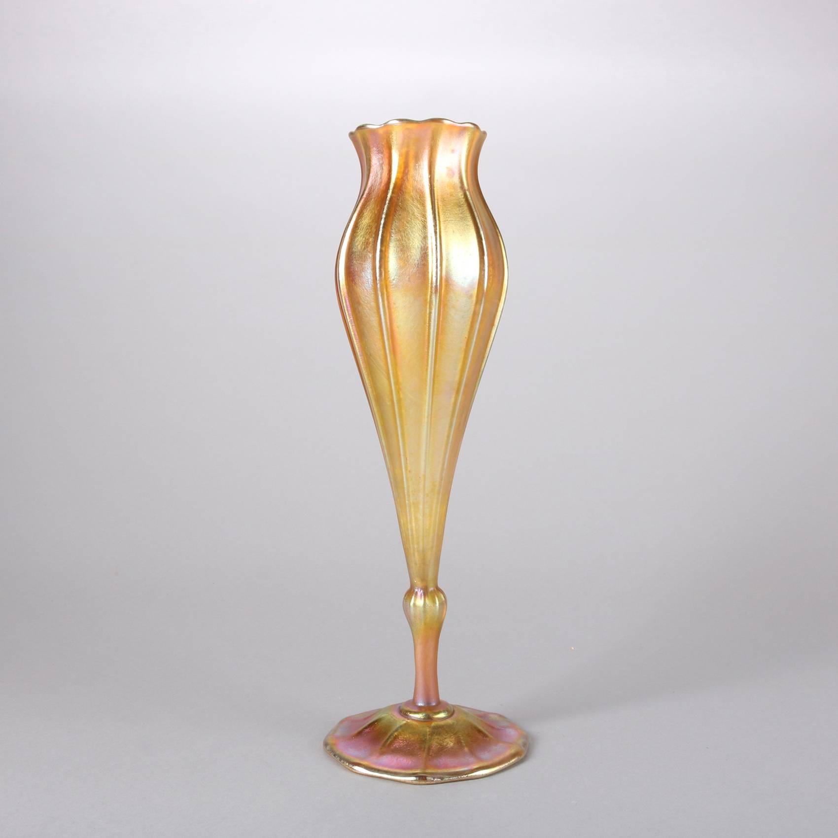 Antique Favrile art glass flora form tulip vase by Louis Comfort Tiffany, signed "5351 J. L.C. Tiffany Favrile" on base, 20th century.

Measures: 11.75" height x 4" diameter.
