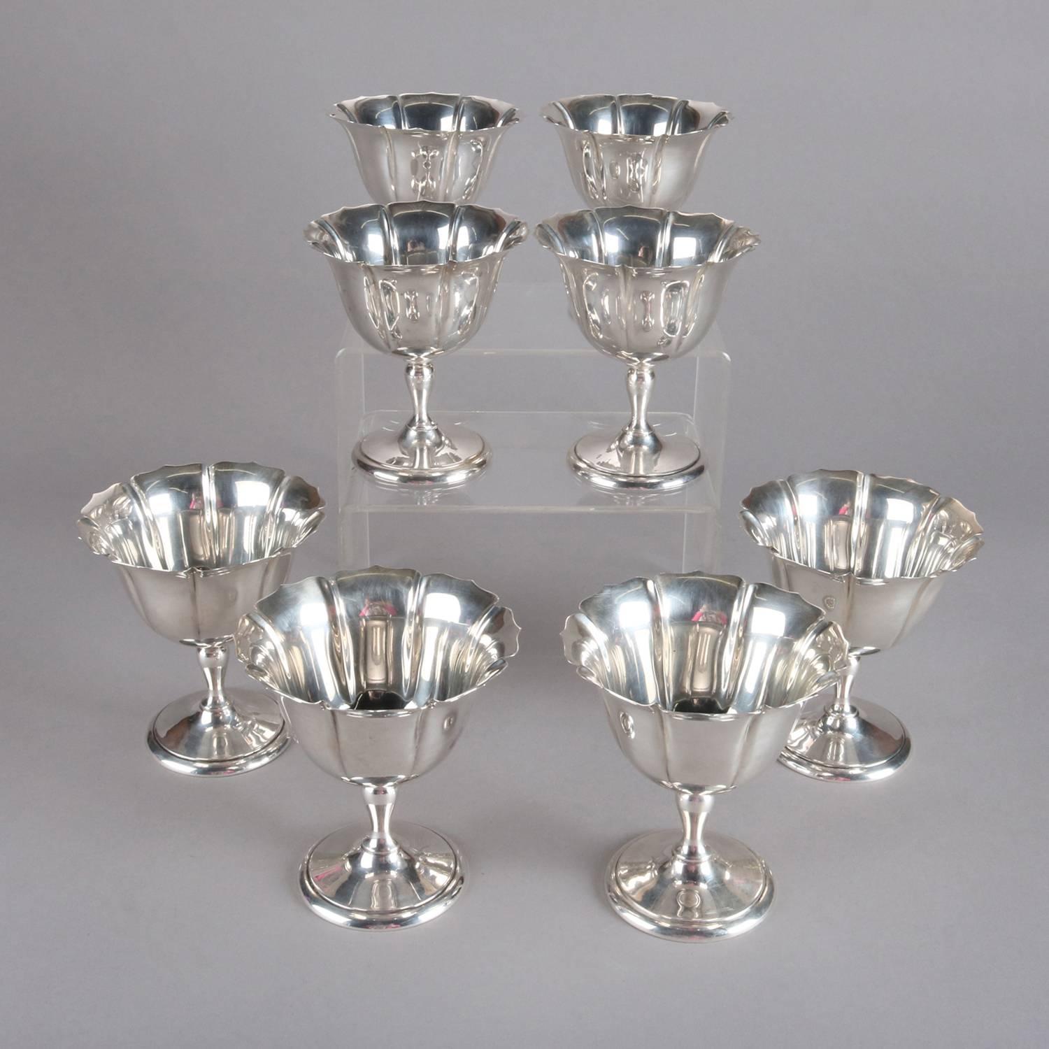 Set of eight sterling silver stemmed dessert cups feature ruffled and fluted cups, marked on base, 20th century

Measures - 4" h x 3.75" op, 2.75" bs