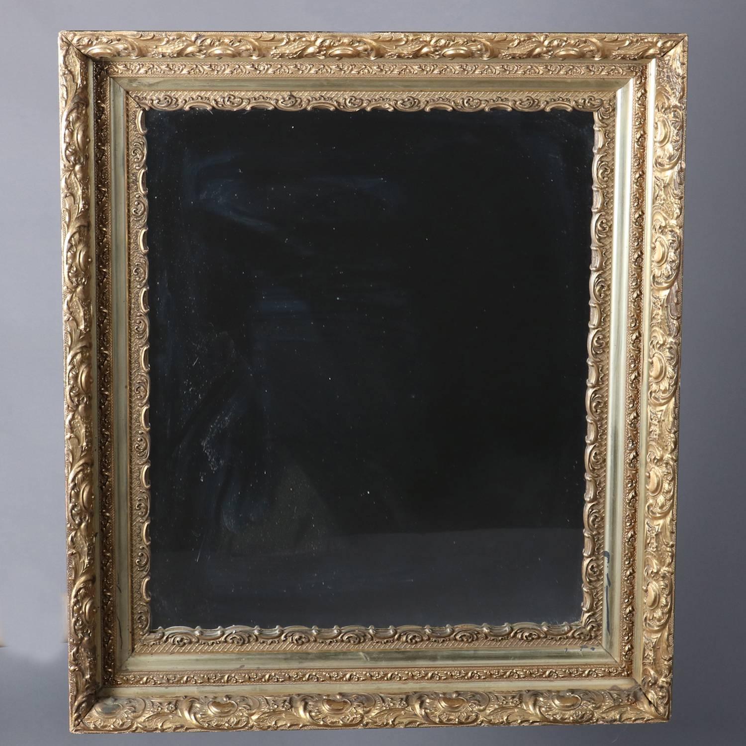 Antique wall mirror features deep gold giltwood frame with scroll and foliate decoration, en verso stamped E. P Co., 19th century


Measures - fr: 31