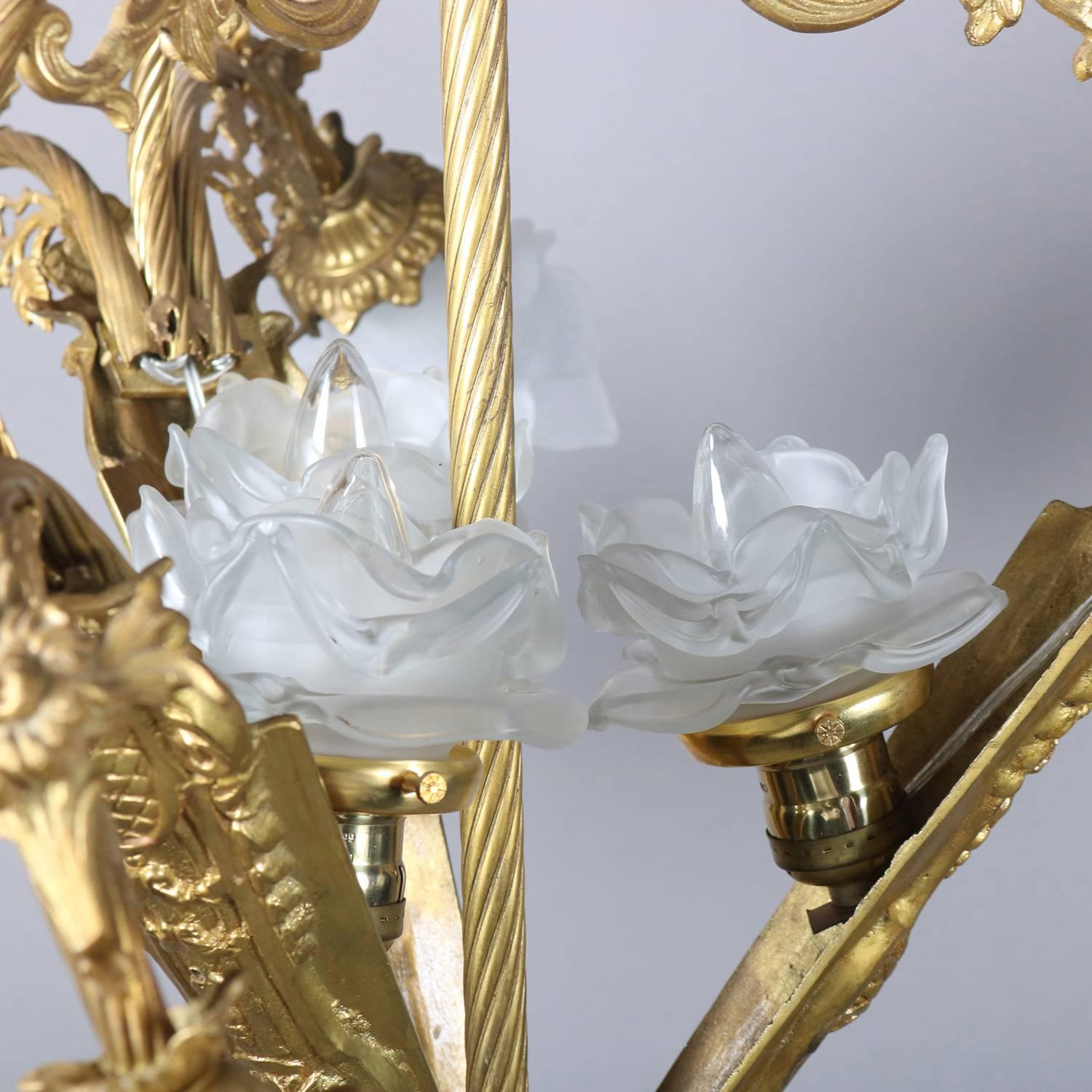 Vintage French Louis XIV style chandelier features gilt foliate form frame, nine arms terminating in lights with frosted molded floral form shades, newly re-wired, 20th century

***DELIVERY NOTICE – Due to COVID-19 we are employing NO-CONTACT