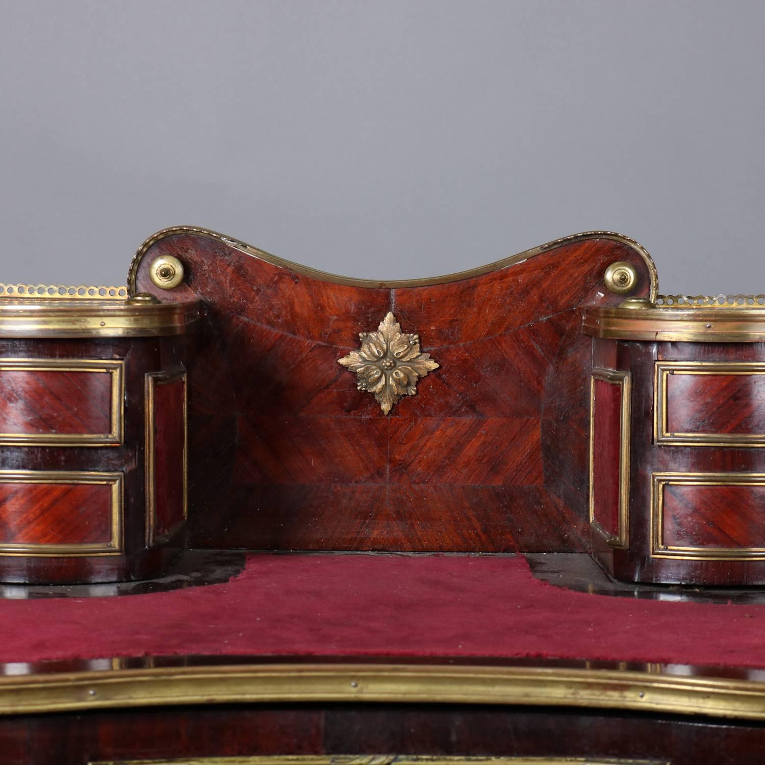 Antique French Louis XIV Style Bonheur de Jour (ladies' desk) features bookmatched rosewood with ormolu trim and mounts throughout, locking central drawer with key,  seated on cabriole legs, writing surface is felt-covered and has backsplash with