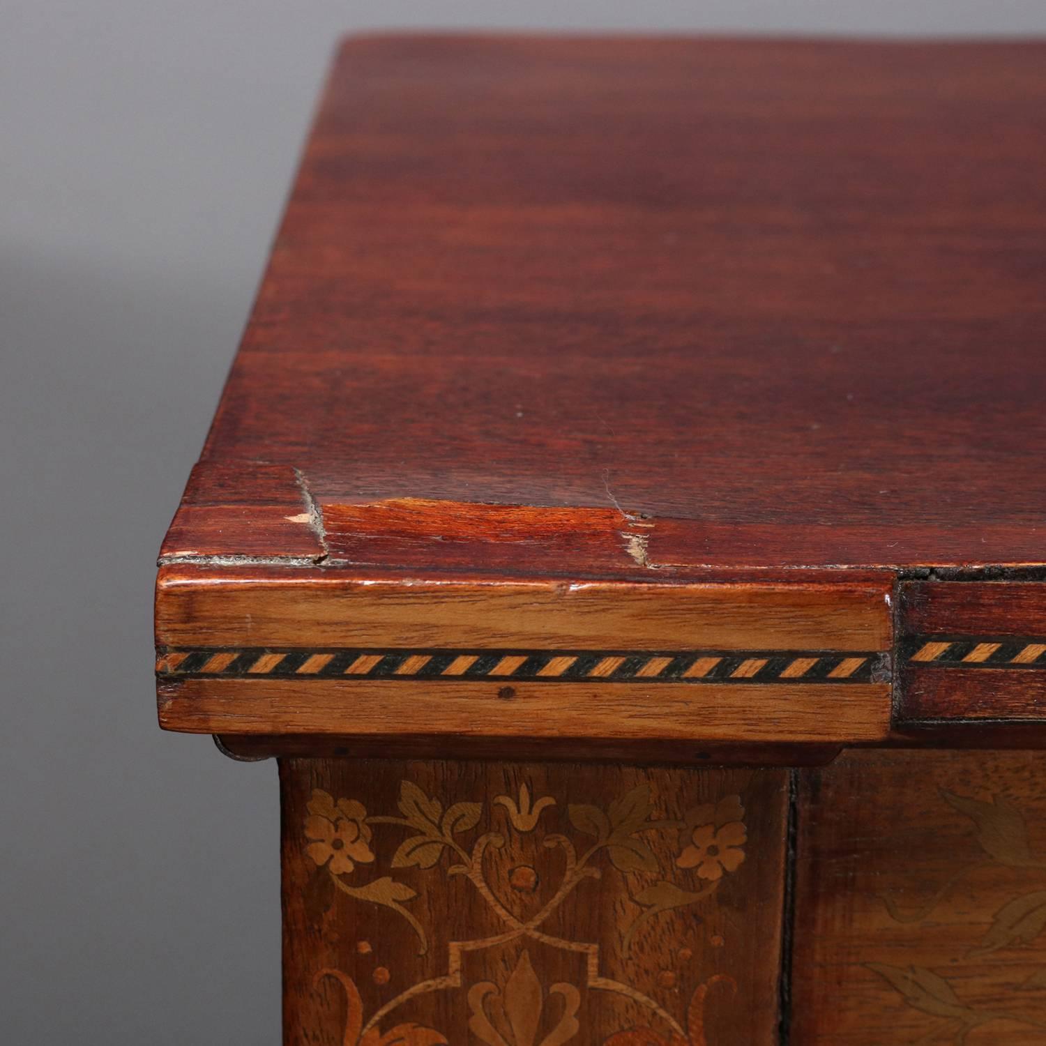 Antique bookcase features mahogany construction with satinwood foliate, bellflower and scroll inlay throughout, banded in ebonized and satinwood, three glass front door open to adjustable shelved interior, 20th century

Measures - 57.75