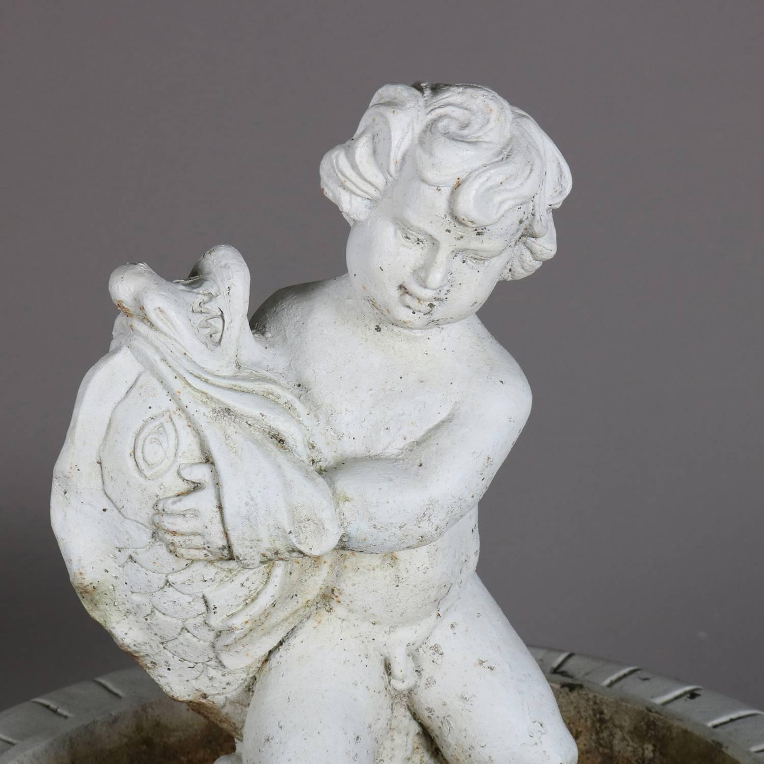 Vintage Fiske School Poseiden cast iron garden bird bath features central cherub in the bowl seated atop plinth surrounded by dolphin and painted white, 20th century.

Measures: 47