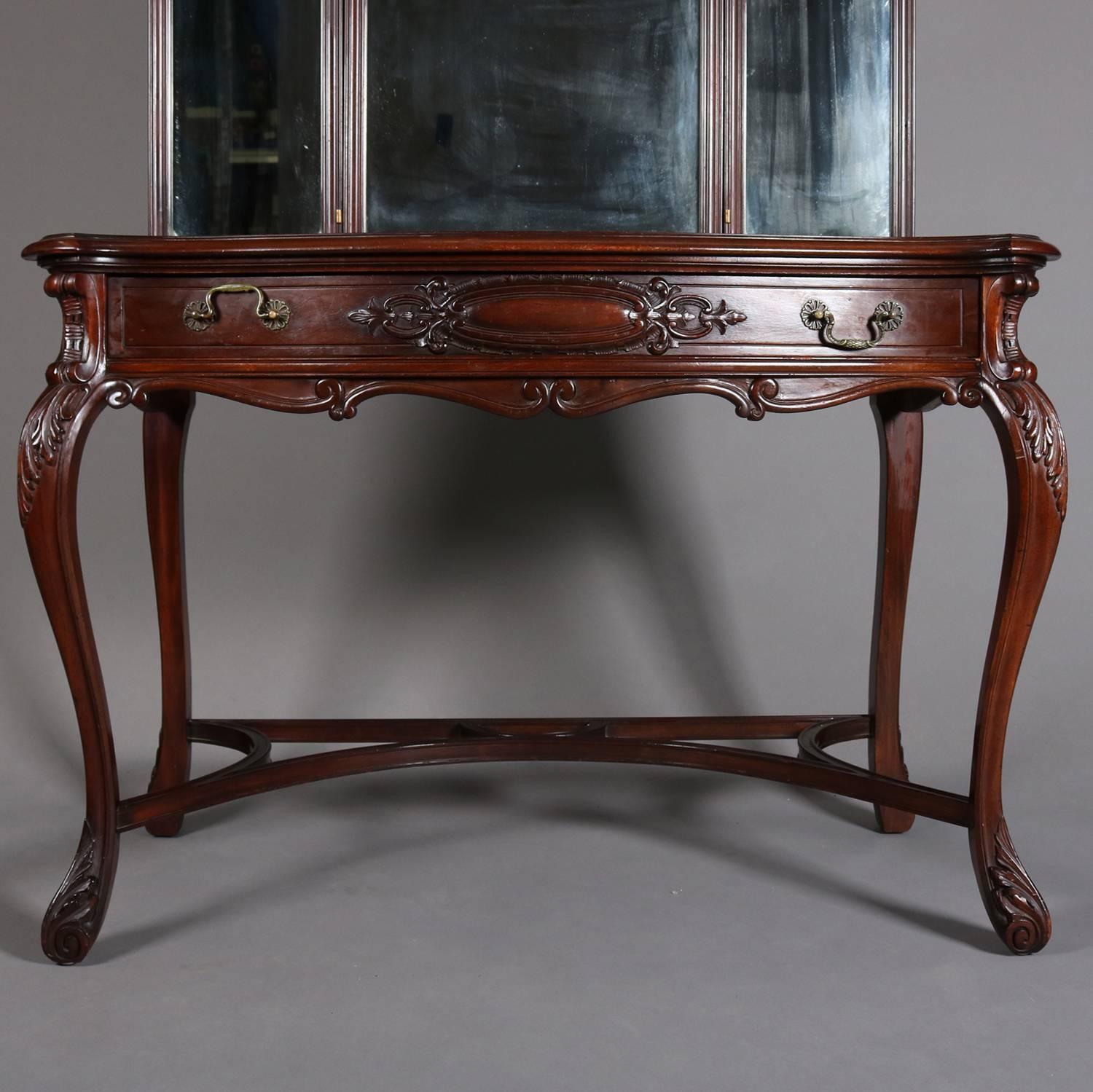 Antique mahogany vanity features carved foliate decoration, has central drawer, triptych mirror, and seated on acanthus carved cabriole legs, bronze pulls, c1890

Measures - 62.5