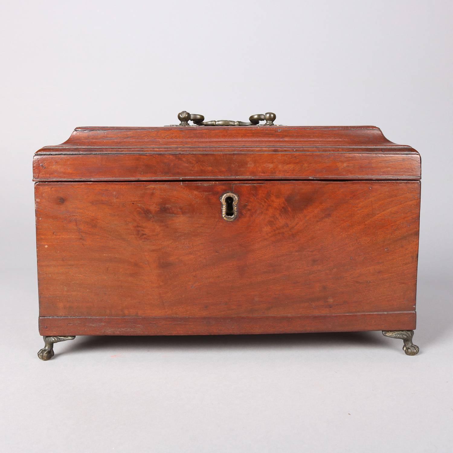 Antique English Regency mahogany tea caddy seated on cast bronze claw and ball feet opens to reveal three interior lidded compartments, 18th century

Measures - 8.25